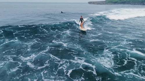 Woman Surfing on Surfboard in Blue Ocean Drone View of Woman During Surfing on Ocean Waves