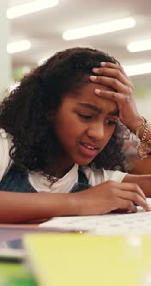 Frustrated, child or difficult homework in library with stress, education burnout