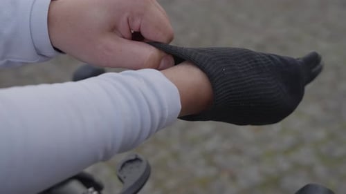 Close Up of Cyclist Putting on Black Gloves
