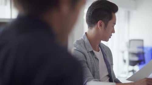 Businessman Reviewing Paperwork in Office Businessman