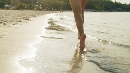 Happy Child Running Barefoot On Ocean Beach At Sunset Summer Vacation Moment