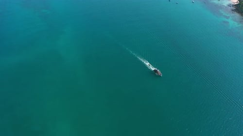 Aerial, ocean or vacation on island with boat, sea or nature for tourism on tropical beach