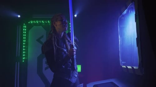 An alien on the spaceship is standing with the lightsaber, 4k