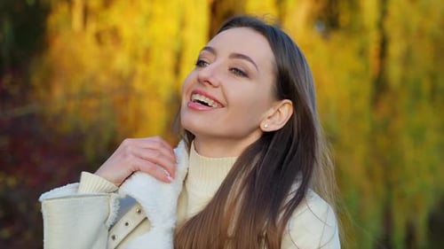 Smiling Woman Enjoying an Autumn Day Outdoors