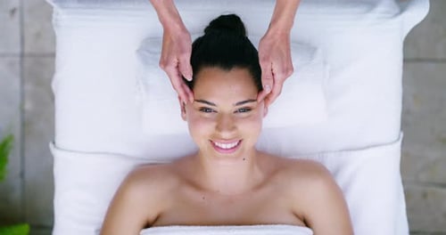 Face, happy woman and spa head massage with hands of masseuse at a wellness therapy resort