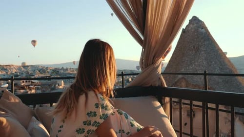Beautiful Tourist Woman Enjoying Incredible View of Hot Air Ballons in Cappadocia During Amazing