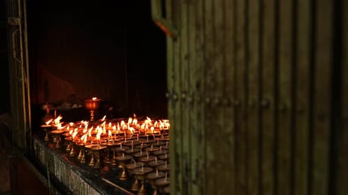 Many Candles Burning At Temple Interior