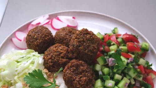Falafel on Plate with Salad and Vegetables