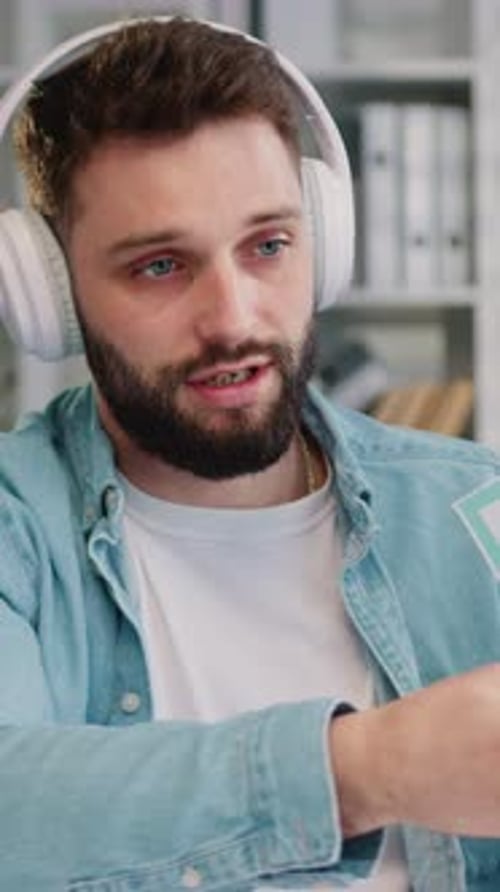 Man Wearing Headphones Talks During Online Meeting