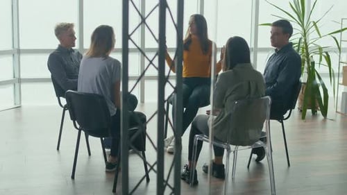 People Sitting in a Circle During a Group Therapy Session Communicate