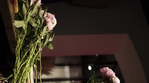 Florist Crafting Bouquet. Florist at Work. Florist makes bouquet in flower shop in Lviv Vertical