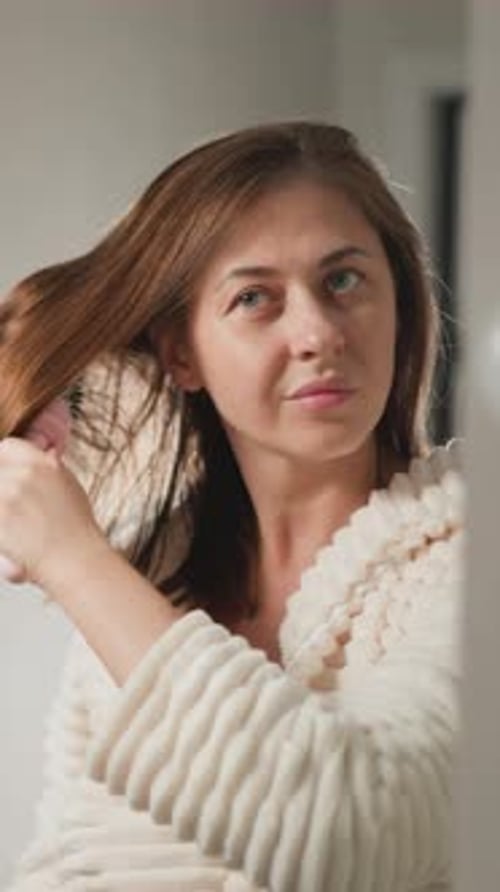 Female Combines Hair with Brush After Taking Shower in Bath