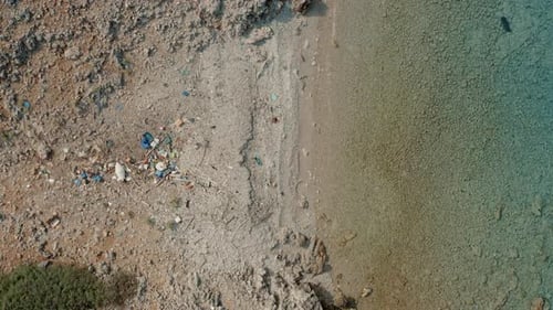 Drone shot of a large amount of plastic trash laying at the beach as environmental issue.