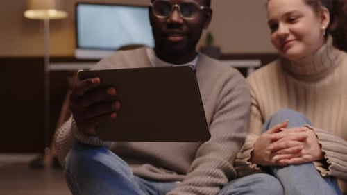 Couple Using Tablet for Video Call Indoors