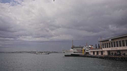 At the Kadıköy pier, in cloudy weather, ships are sailing, birds are flying, on the Bosphorus.