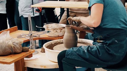 Un potier façonne de l'argile sur un tour de poterie