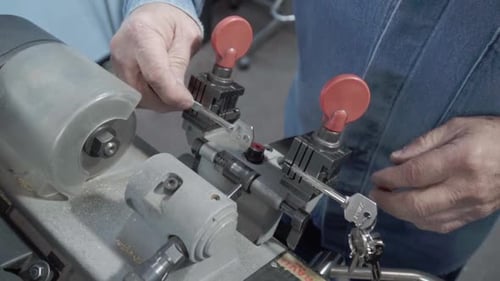 Hispanic man working workshop specializing in lock repair and maintenance. Key duplication. Mexico.