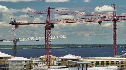 Tower Cranes and Frame Structure of High Residential Apartment Buildings at Construction Site