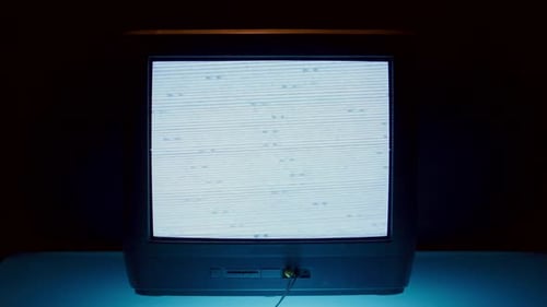 Old Television with Static Screen in Dark Room
