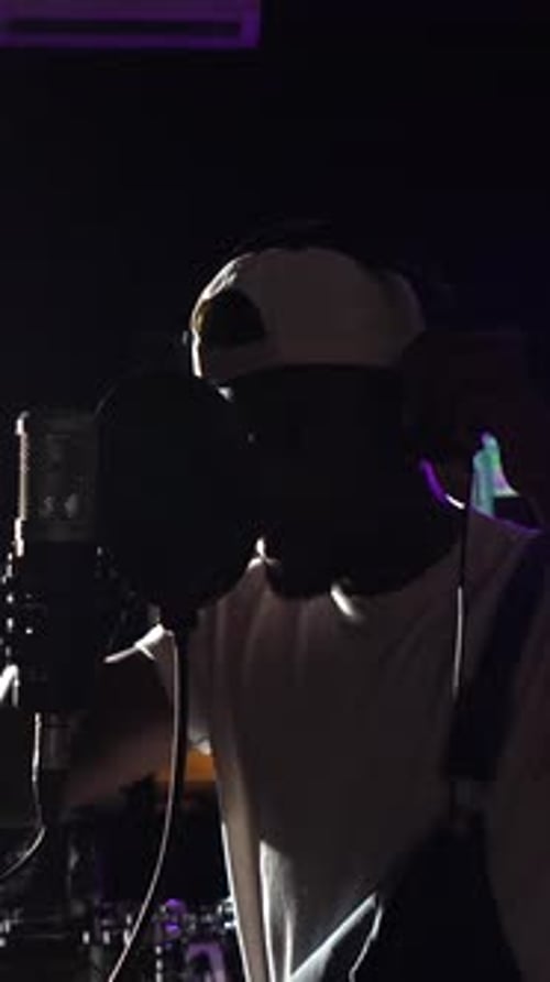 Young african american singer recording album in music studio