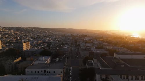 Witness a Stunning Sunset Over a Cityscape with an Aerial View of the Bustling Streets