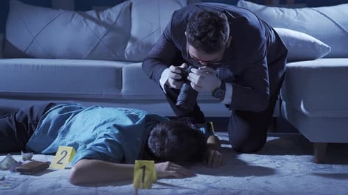 Detective Photograping Evidence at Crime Scene