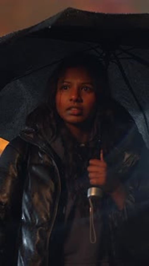 Woman with Umbrella Standing in Night Rain