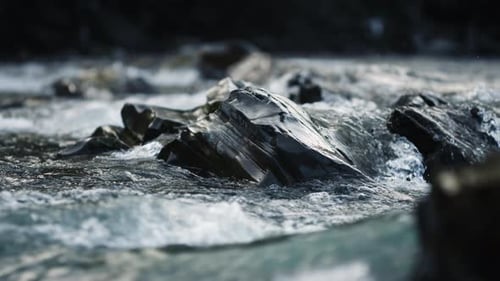 Clear stream running through stone boulders in the ukrainian carpathians