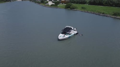 Aerial view of a wakeboarding sport boat practice on the lake with calm water