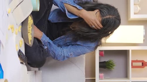 Person with Headache Sitting Indoors on Sofa