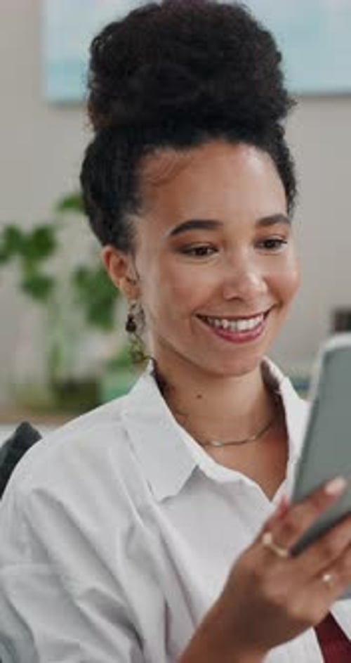 Smiling Woman Using Tablet Device Indoors