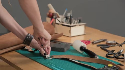 Female Workers Hands Making Holes in Leather Belt