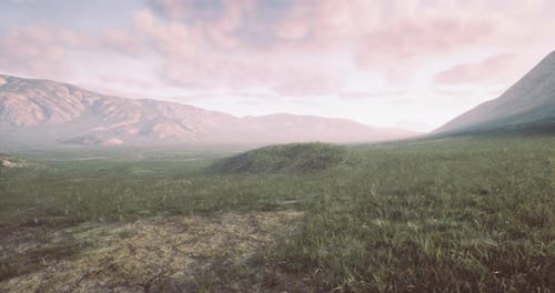 Landscape View of Rolling Hills and Distant Mountains During Sunset