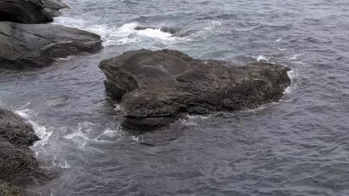 Sea shore and stones. Seascape with gushing waves on the coast