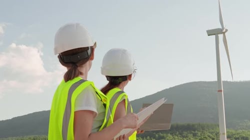 Engineers Conducting Detailed Inspections on Wind Turbines Located at a Renewable Energy Production