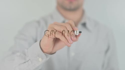 Writing the Words Gay Rights on Transparent Surface