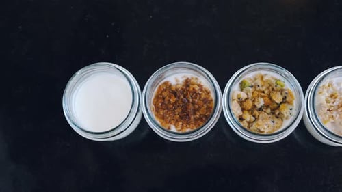 Top View of Yogurt with Muesli on a Black Background