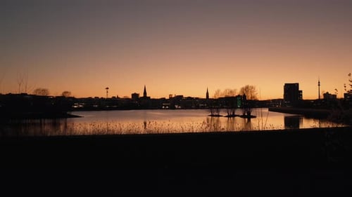 Silhouetted Cityscape and Lake Reflections After Sunset at Phoenix-See, Dortmund
