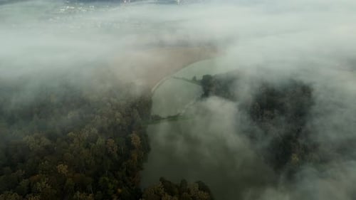 Aerial View of Forest, River, and Foggy Town