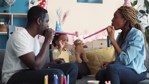 Happy family celebrates a toddler's birthday at home