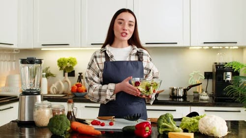 Woman Preparing Salad in a Modern Kitchen