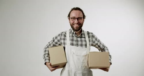 Smiling Adult Holds Boxes in Studio