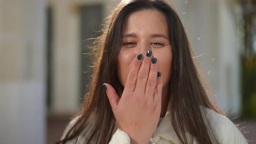 Headshot Portrait of Coquette Young Woman Gesturing Air Kiss Smiling Looking at Camera