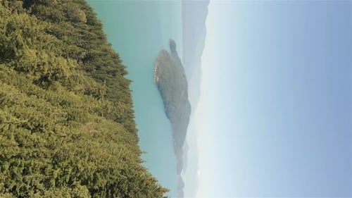 Aerial View of Lake and Green Trees in Forest Around Mountain Landscape