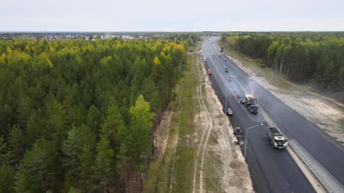 Repair and laying of asphalt pavement on four-lane highway. Drone cinematic view
