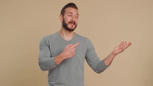 Lebanese Man Showing Thumbs Up and Pointing Empty Blank Place Advertising Area for Commercial Text