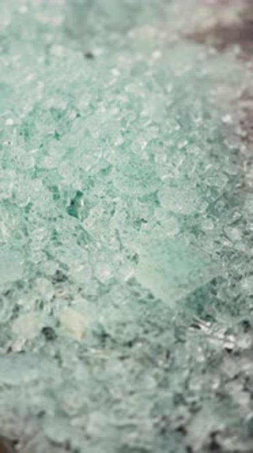 A Close Up of Shattered Glass on Icy Soil in Winter