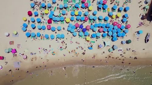 Summertime in a public Beach with colorful umbrellas