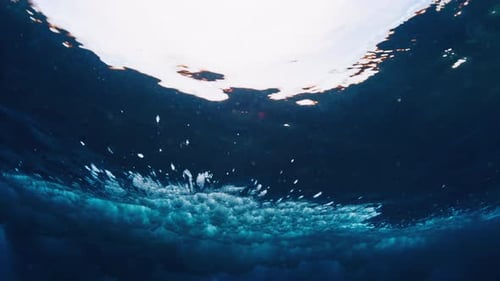 Ocean wave. Underwater view of the crystal clear ocean wave breaking in Maldives