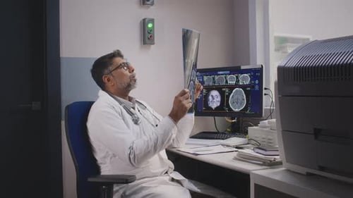 Doctor Examining Brain Scan in Hospital Office